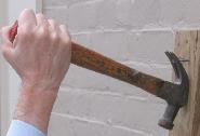 Using a hammer to pull out nails
